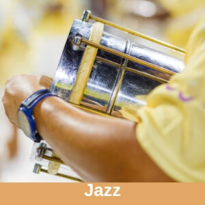 You can see the art of a person with brown skin and a yellow shirt holding a silver metal drum. Genre label reads, "jazz."